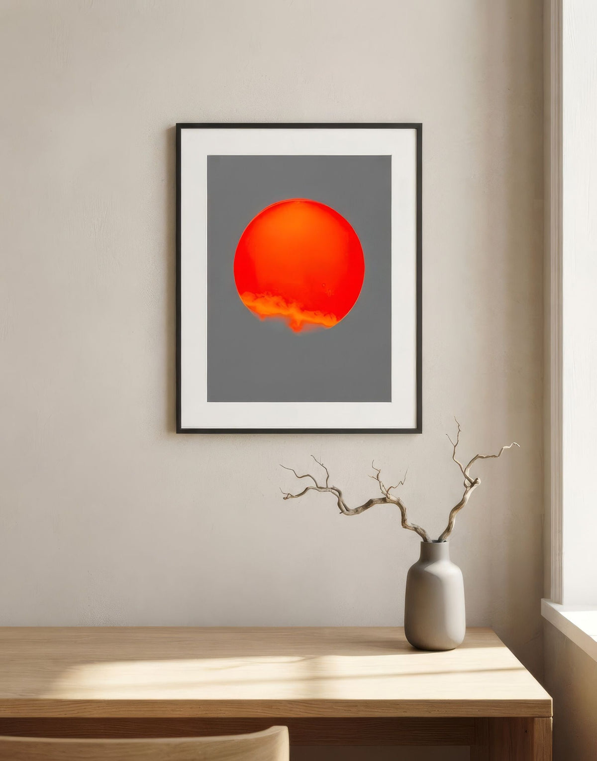 Archival print of a red sun, framed in a living room
